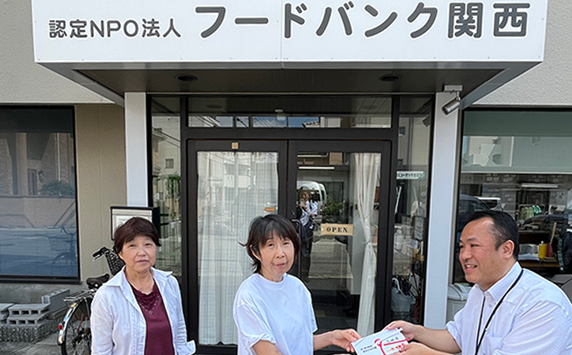 認定NPO法人フードバンク関西様の事務所の前で、寄付されたものをお渡ししているイメージ